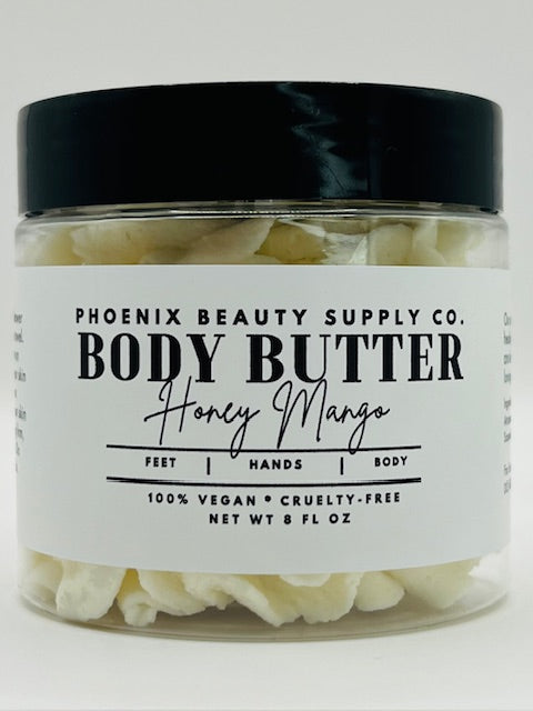 Jar of Honey Mango Whipped Body Butter with rich, creamy texture for deep hydration and glowing skin